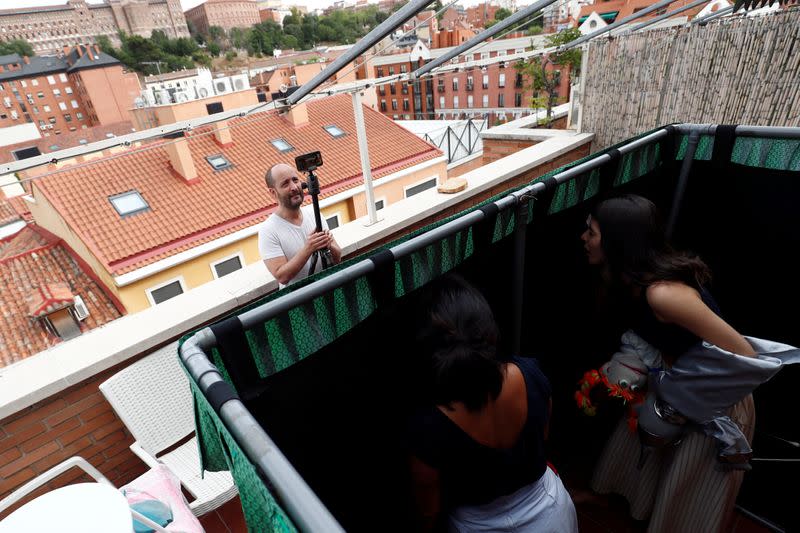 Actress and puppeteer Yohana Yara performs with her colleague Alicia Lorente as Jerome Rader films their puppet show at her home in Madrid