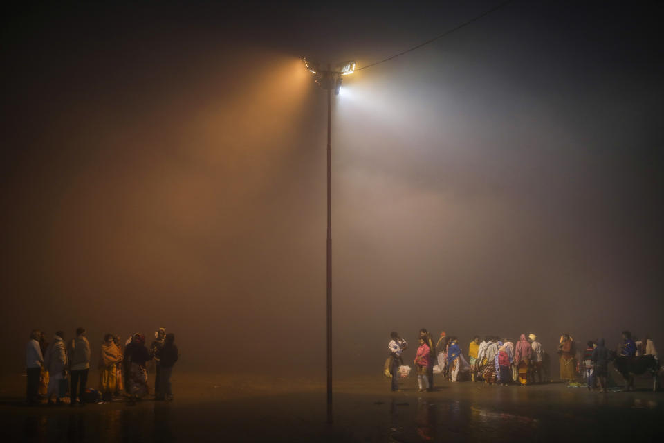 Hindu pilgrims arrive to takes holy dips before sunrise during Makar Sankranti festival on Sagar Island, an island in the Ganges delta, India, Monday, Jan. 13, 2020. Sagar and many other small islands which are part of the Sundarbans, the world's largest mangrove forest, have seen a dramatic rise in sea levels due to climate change. The highest point in the Sundarbans is around 3 meters (9.8 feet) and the mean elevation is less than a meter above sea level. (AP Photo/Altaf Qadri)