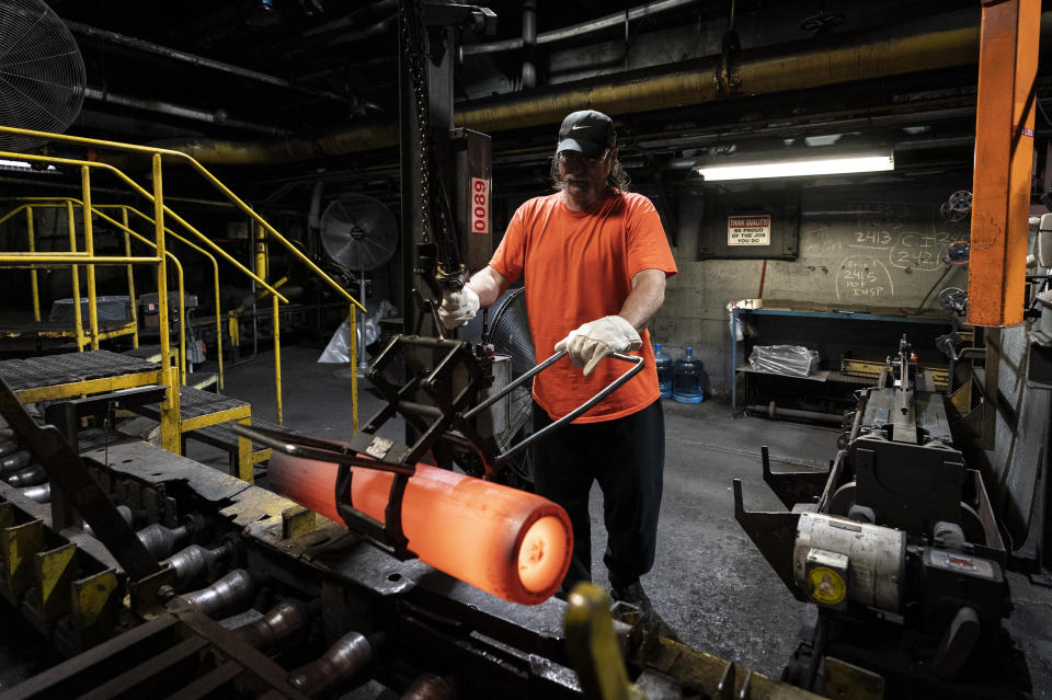 A steel worker removes a heated 155 mm M795 artillery projectile for testing during the manufacturing process at the Scranton Army Ammunition Plant in Scranton, Pa., Thursday, April 13, 2023. One of the most important munitions of the Ukraine war comes from a historic factory in this city built by coal barons, where tons of steel rods are brought in by train to be forged into the artillery shells Kyiv can’t get enough of — and that the U.S. can’t produce fast enough. (AP Photo/Matt Rourke)