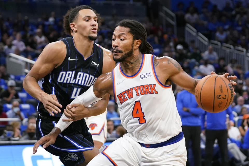 Orlando Magic's Jalen Suggs, left, fouls New York Knicks' Derrick Rose, who was headed to the basket during the first half of an NBA basketball game Friday, Oct. 22, 2021, in Orlando, Fla. (AP Photo/John Raoux)