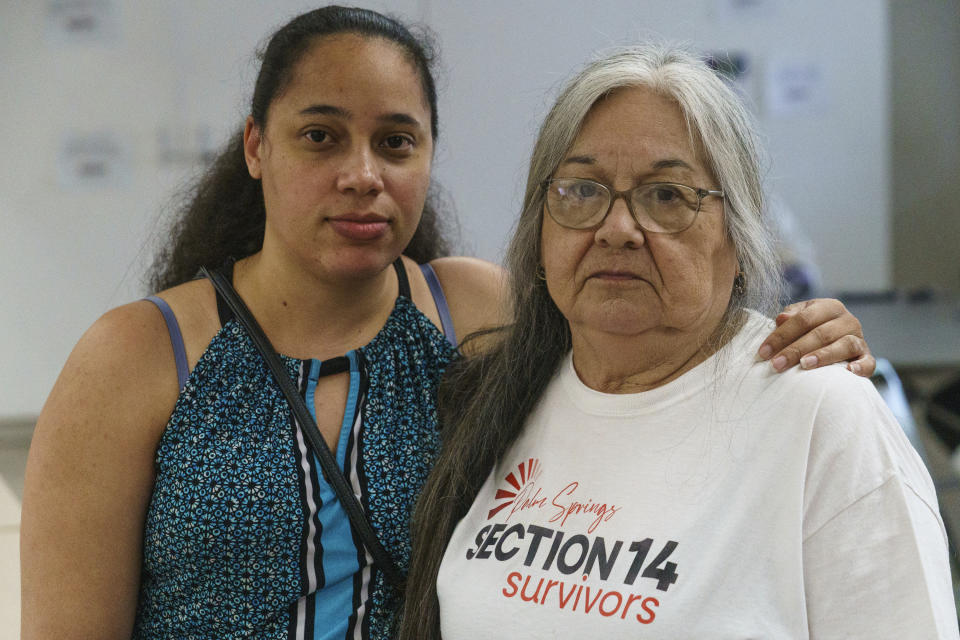 Stephanie Brown, 33, descendant of Mary Moore and granddaughter of Willie and Rebecca Moore, survivors of Section 14, left, and Priscilla Ruiz Olvera, 73, stand together for a portrait at the United Methodist Church in Palm Springs, Calif., Sunday, April 16, 2023. Black and Latino Californians who were displaced from their Section 14 neighborhood in Palm Springs allege the city pushed them out by hiring contractors to destroy homes in an area that was tight-knit and full of diversity. (AP Photo/Damian Dovarganes)