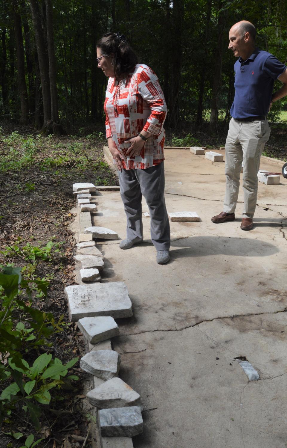 The remains of a number of broken and vandalized tombstones were found scattered across the lot.