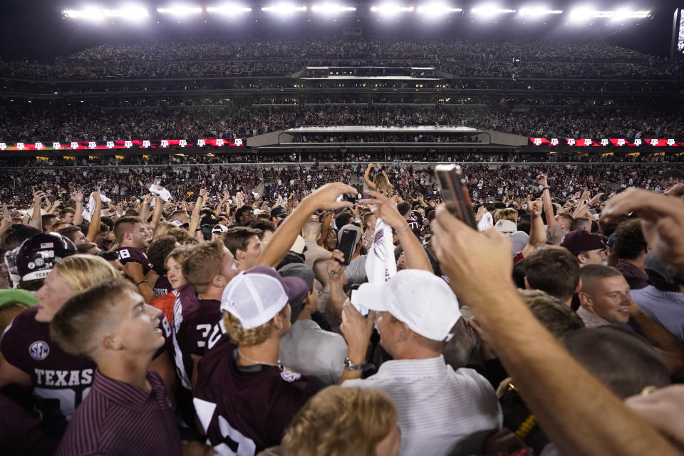 Fans celebrate after Texas A&M upset Alabama in an NCAA college football game Saturday, Oct. 9, 2021, in College Station, Texas. (AP Photo/Sam Craft)