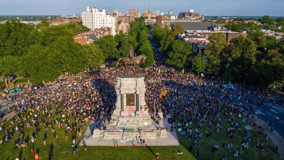 A large group of protesters gather around the statue of Confederate General Robert E. Lee on Monument Avenue near downtown in Richmond, Virginia on Tuesday, June 2, 2020.