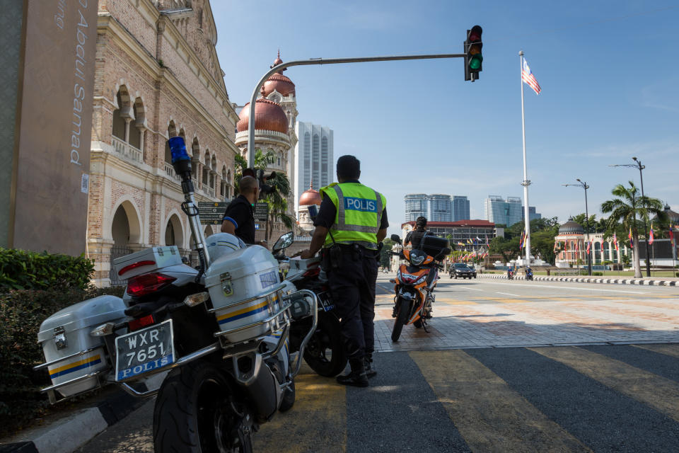 Police officers on duty at Kuala Lumpur's Merdeka Square on 18 March 2020, the first day of the Movement Control Order. (PHOTO: Fadza Ishak for Yahoo Malaysia)