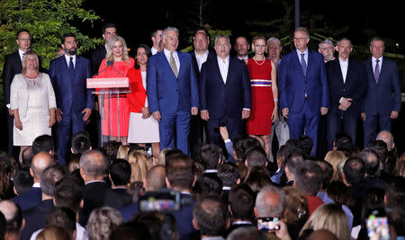 Hungarian Prime Minister Viktor Orban sings the national anthem after addressing supporters, following the preliminary results of the European Parliament election in Budapest, Hungary, May 26, 2019. REUTERS/Bernadett Szabo