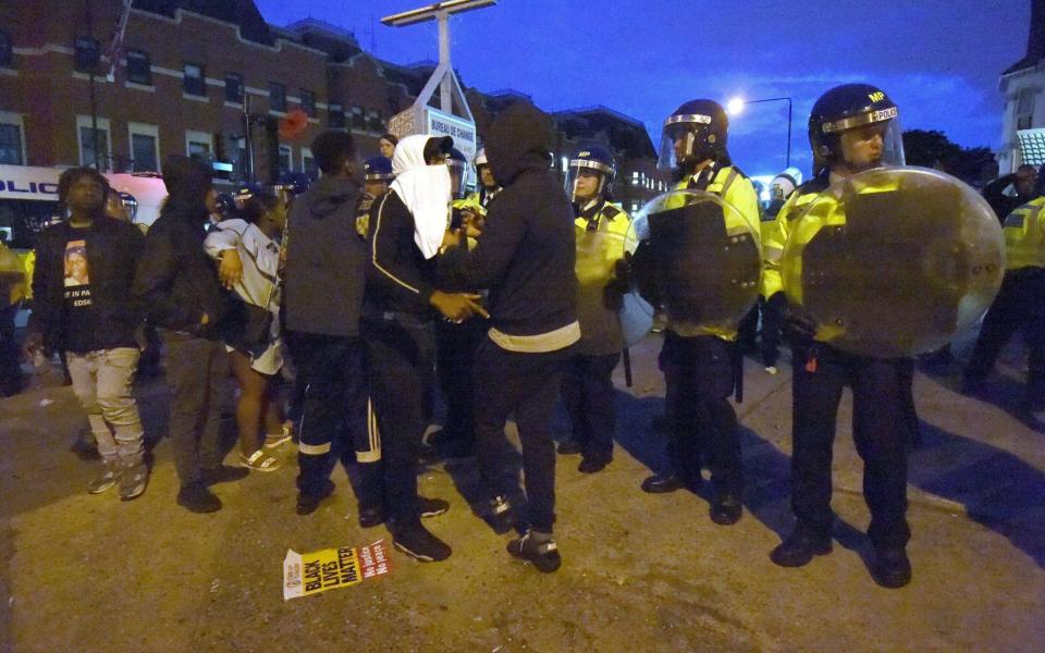 Campaigners face off with police near in Forest Gate, north east London, as they protest over the death of Edir Frederico Da Costa - Credit: Lauren Hurley /PA