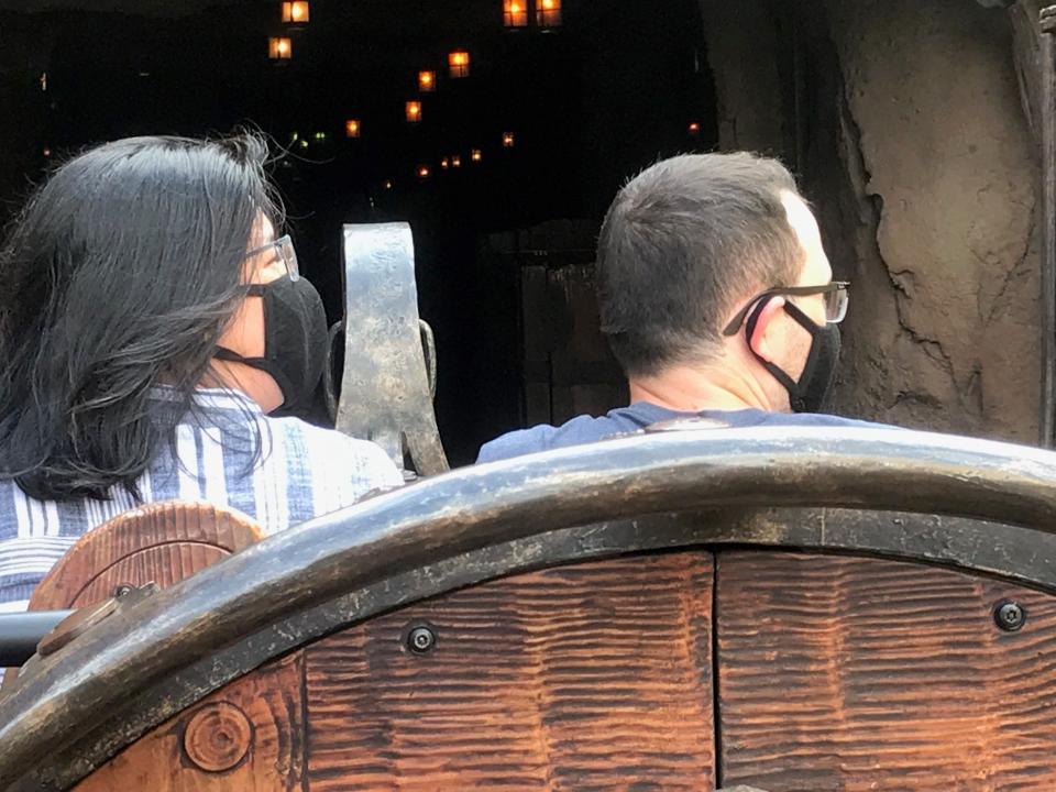 Masks are mandatory now at Walt Disney World, where a couple wearing face coverings is pictured Thursday during the first day of a passholder preview before the park officially reopens Saturday.