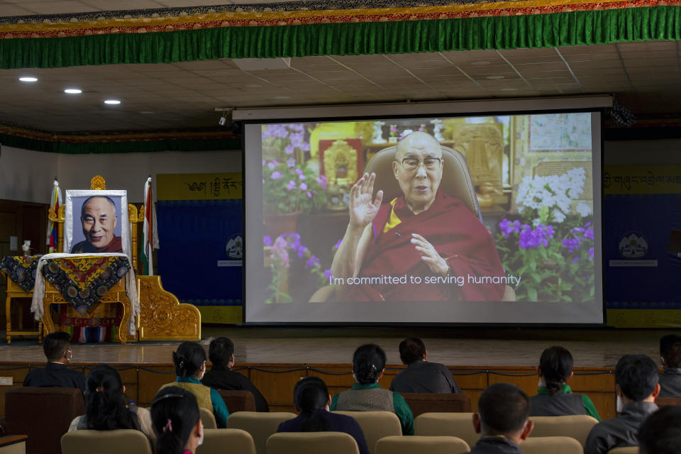 Exile Tibetan government officials watch a message from their spiritual leader the Dalai Lama on a screen during a ceremony to mark the 86th birthday of the Tibetan leader in Dharmsala, India, Tuesday, July 6, 2021. This year, due to the coronavirus pandemic, the celebrations were muted and behind closed doors. (AP Photo/Ashwini Bhatia)