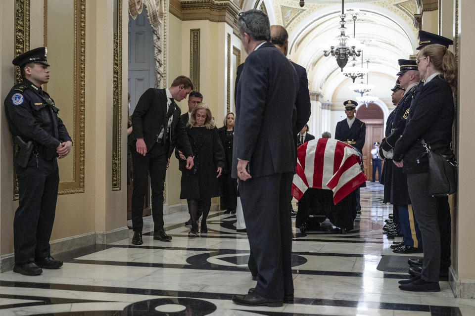 Anne Young, third from left, is escorted past the casket of her husband, former Rep. Don Young, R-Alaska, before a ceremony for her husband at the U.S. Capitol in Washington, Tuesday, March 29, 2022. (Jim Watson/Pool Photo via AP)