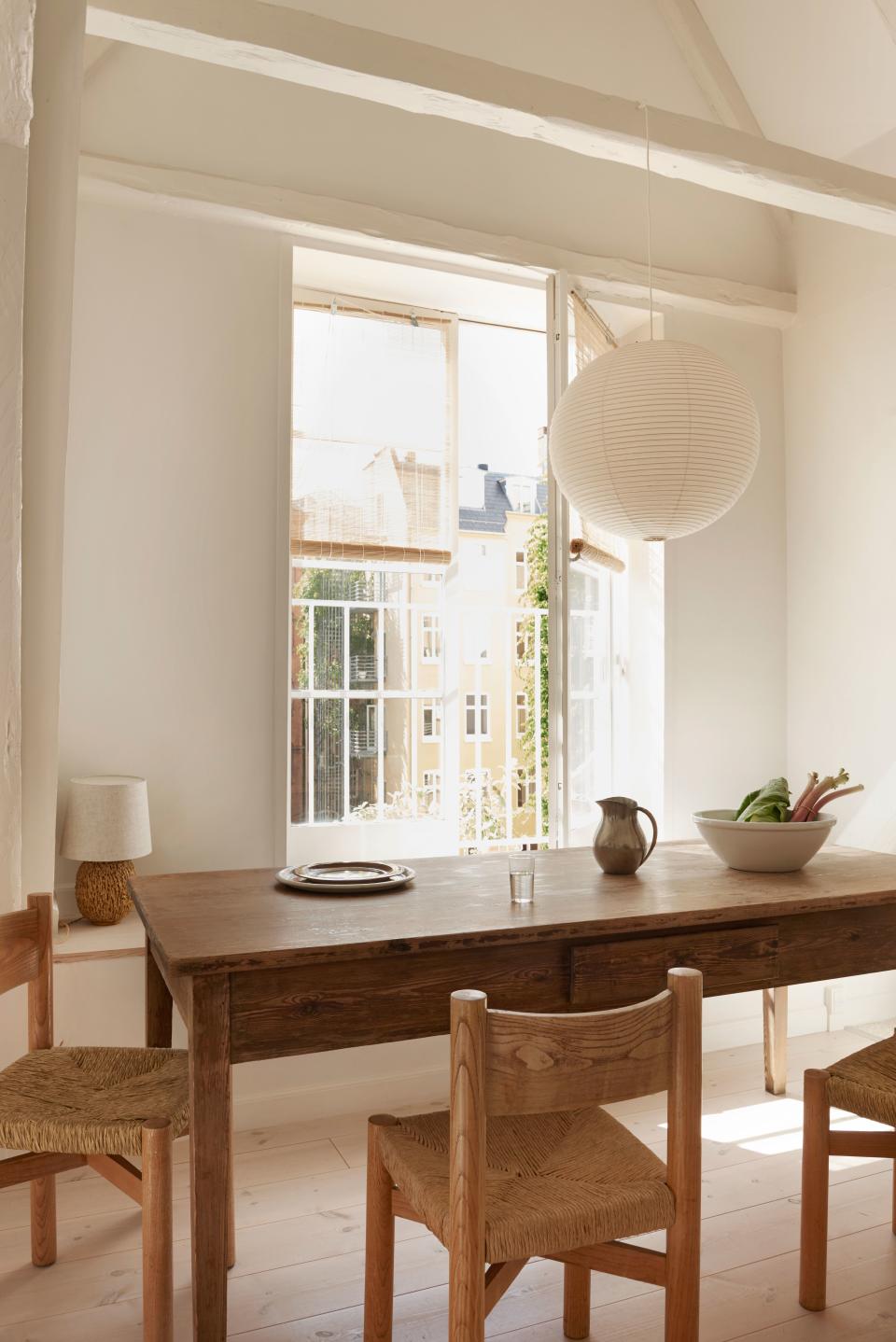 A large table by the kitchen is where the Feiffers spend the majority of their time: “It’s the center of our home. We have dinners here, co-work here, and have creative conversations here—with plenty of ceiling height for debate.” Bamboo roller shades soften the bright light just enough. Dining chairs are original Meribel chairs designed by Charlotte Perriand.