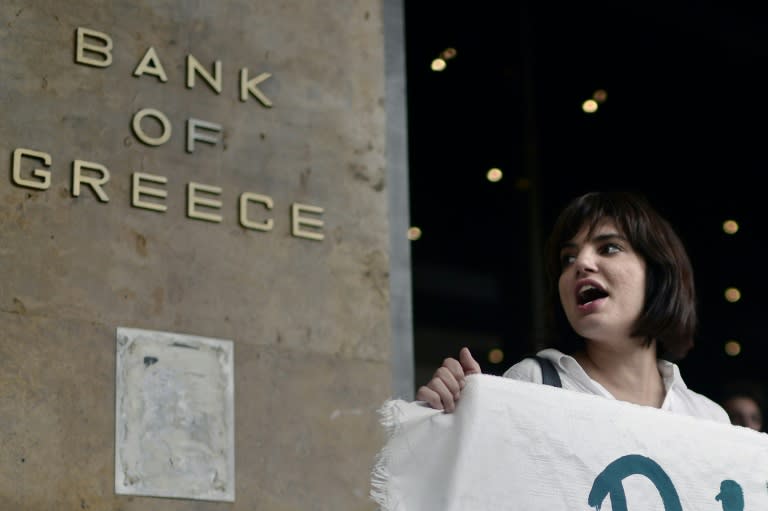 A young protester demands the resignation of the Bank of Greece governor during an anti-austerity rally in Athens, on June 22, 2015