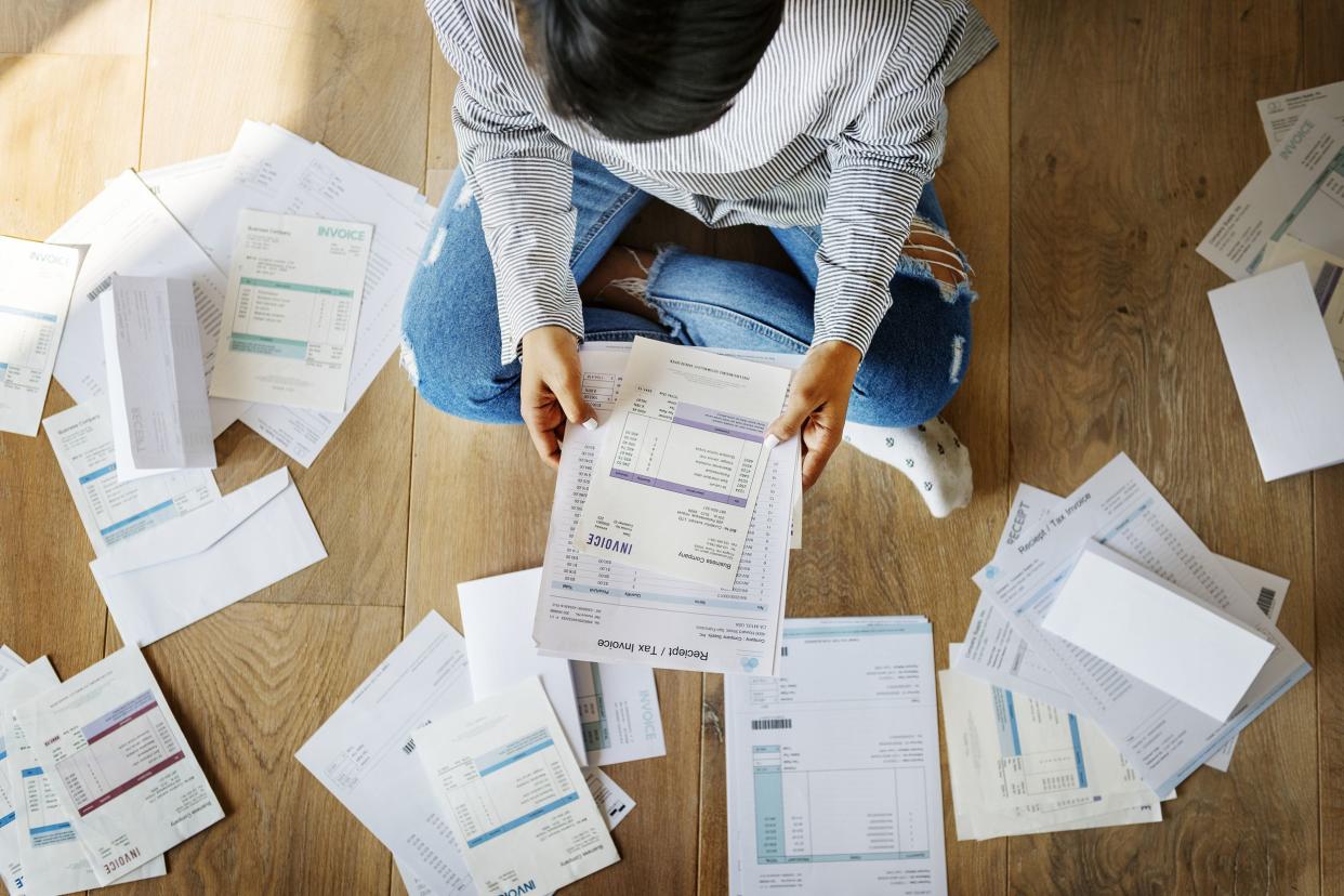 woman organizing papers on the floor