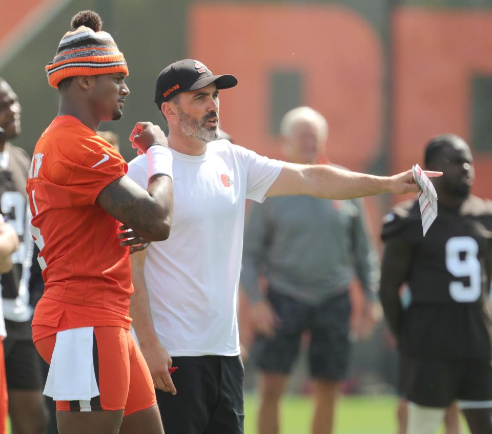 Browns quarterback Deshaun Watson talks with coach Kevin Stefanski during a workout June 8, 2022, in Berea.