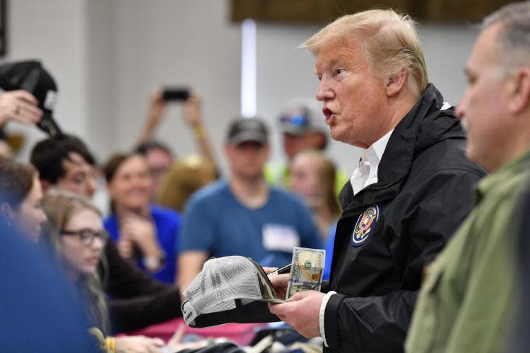 Trump autographs bibles while meeting Alabama tornado victims