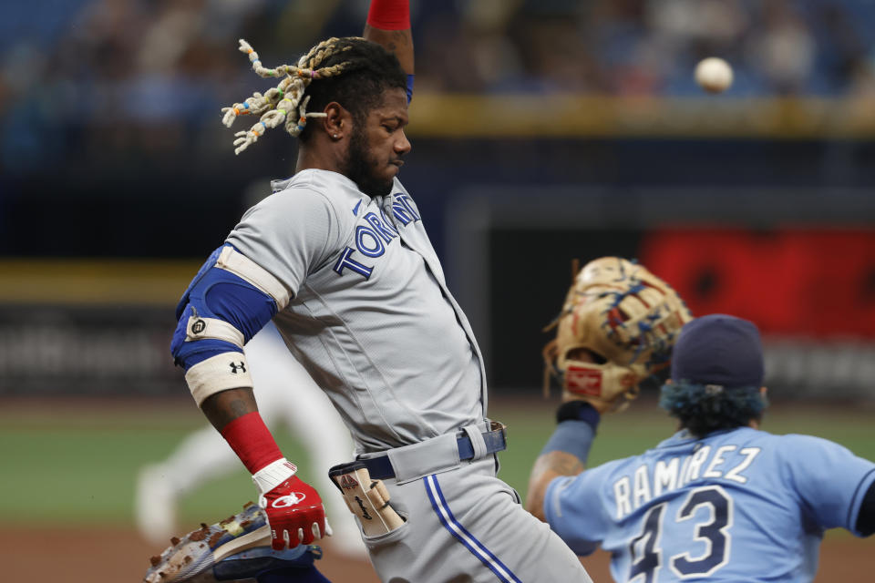 Toronto Blue Jays' Raimel Tapia, left, beats the throw to Tampa Bay Rays first baseman Harold Ramirez during the third inning of a baseball game Sunday, Sept. 25, 2022, in St. Petersburg, Fla. (AP Photo/Scott Audette)