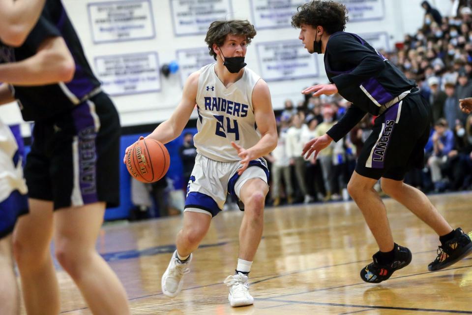 Dover-Sherborn sophomore Brian Olson drives to the basket during the boys basketball game against Norton High on Feb. 15.