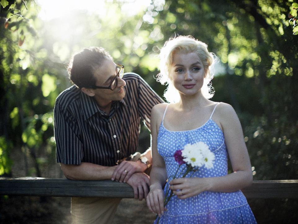 Arthur Miller and Marilyn standing together outside in the movie