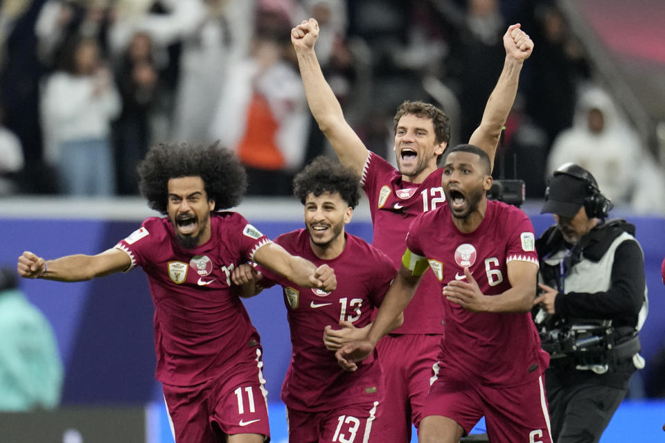 Qatar players celebrate after their win in the Asian Cup quarterfinal soccer match between Qatar and Uzbekistan at Al Bayt Stadium in Al Khor, Qatar, Saturday, Feb. 3, 2024. (AP Photo/Aijaz Rahi)