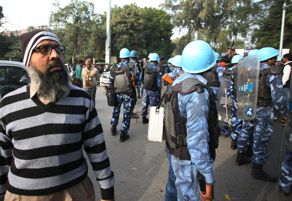 A protester stand near police security officials during a demonstration against India's new citizenship law CAA ( Citizenship amandment Act ) in Allahabad on December 19,2019 . Indians defied bans nationwide as anger swells against a citizenship law seen as discriminatory against muslims, following days of protest, clashes, and riots that have left six dead .(Photo by Ritesh Shukla/NurPhoto via Getty Images)