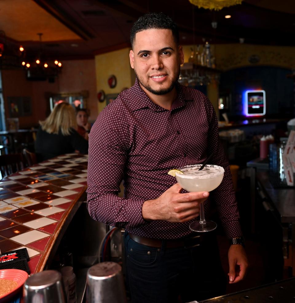 Michael Hernandez, director of operations at four area Margaritas Mexican Restaurants, holds a house margarita drink at the chain's Framingham restaurant, Sept. 9, 2022. Nine years ago, Hernandez moved from the Dominican Republic to the United States and has since worked his way up in the restaurant industry, starting as a line cook.