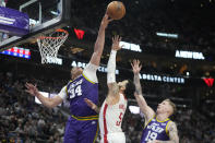 Utah Jazz Kenneth Loft Jr., left, blocks the shot of Houston Rockets guard Fred VanVleet (5) during the second half of an NBA basketball game Thursday, April 11, 2024, in Salt Lake City. (AP Photo/Rick Bowmer)