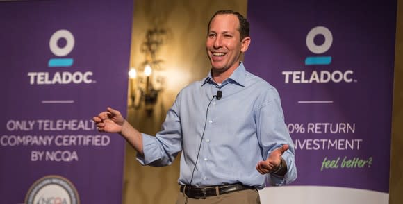 Teladoc CEO Jason Gorevic in front of banners promoting Teladoc.