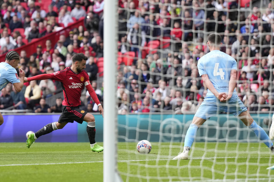 Manchester United's Bruno Fernandes scores his side's third goal during the English FA Cup semifinal soccer match between Coventry City and Manchester United at Wembley stadium in London, Sunday, April 21, 2024. (AP Photo/Alastair Grant)