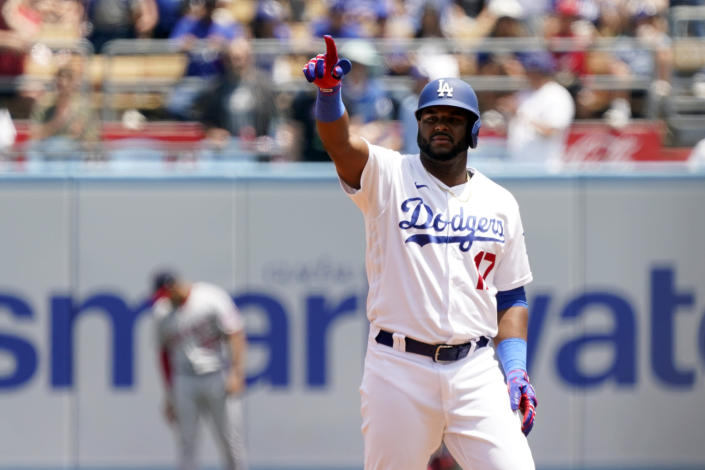 Los Angeles Dodgers' Hanser Alberto points to the dugout after driving in two runs with a double during the first inning of a baseball game against the Washington Nationals, Wednesday, July 27, 2022, in Los Angeles. (AP Photo/Marcio Jose Sanchez)