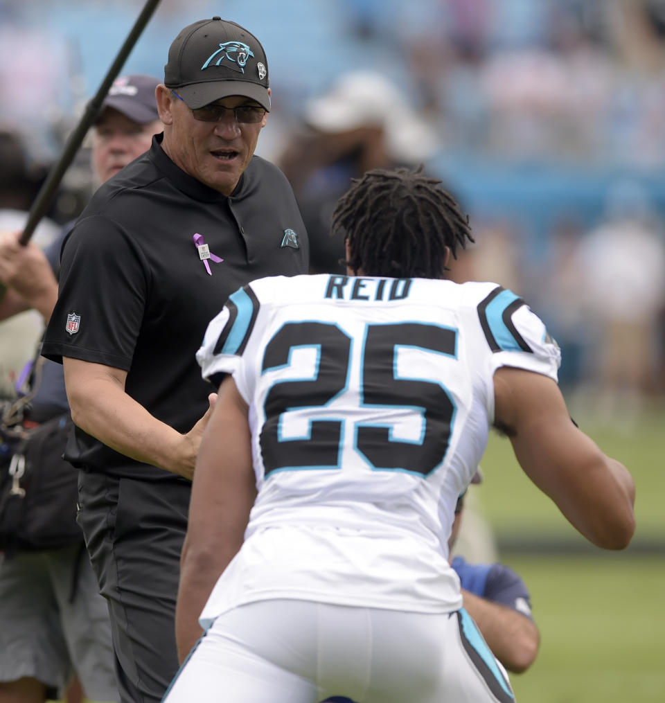 Carolina Panthers head coach Ron Rivera greets Eric Reid (25) before an NFL football game against the New York Giants in Charlotte, N.C., Sunday, Oct. 7, 2018. (AP Photo/Mike McCarn)