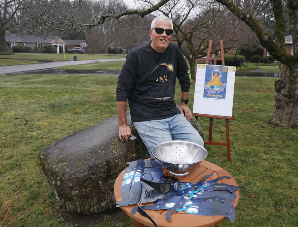 Wearing one of his many pair of solar eclipse glasses, Patrick Moriarty poses in his yard in Rochester Friday, March 15, 2024. Moriarty, a former Webster earth science teacher, is reconnecting with past students who he has invited to his eclipse watching party. Moriarty plans to have all his guests sign his Rochester eclipse poster as a keepsake of the event.