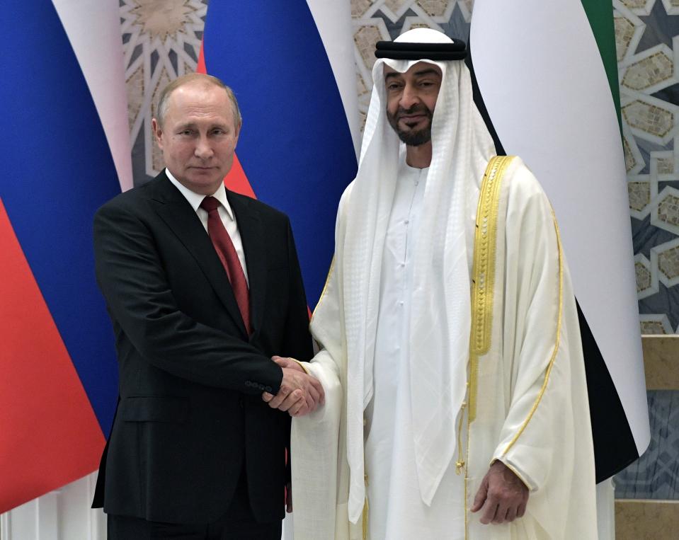 Russian President Vladimir Putin, left, and Abu Dhabi Crown Prince Mohamed bin Zayed al-Nahyan pose for a photo during the official welcome ceremony in Abu Dhabi, United Arab Emirates, Tuesday, Oct. 15, 2019. (Alexei Nikolsky, Sputnik, Kremlin Pool Photo via AP)