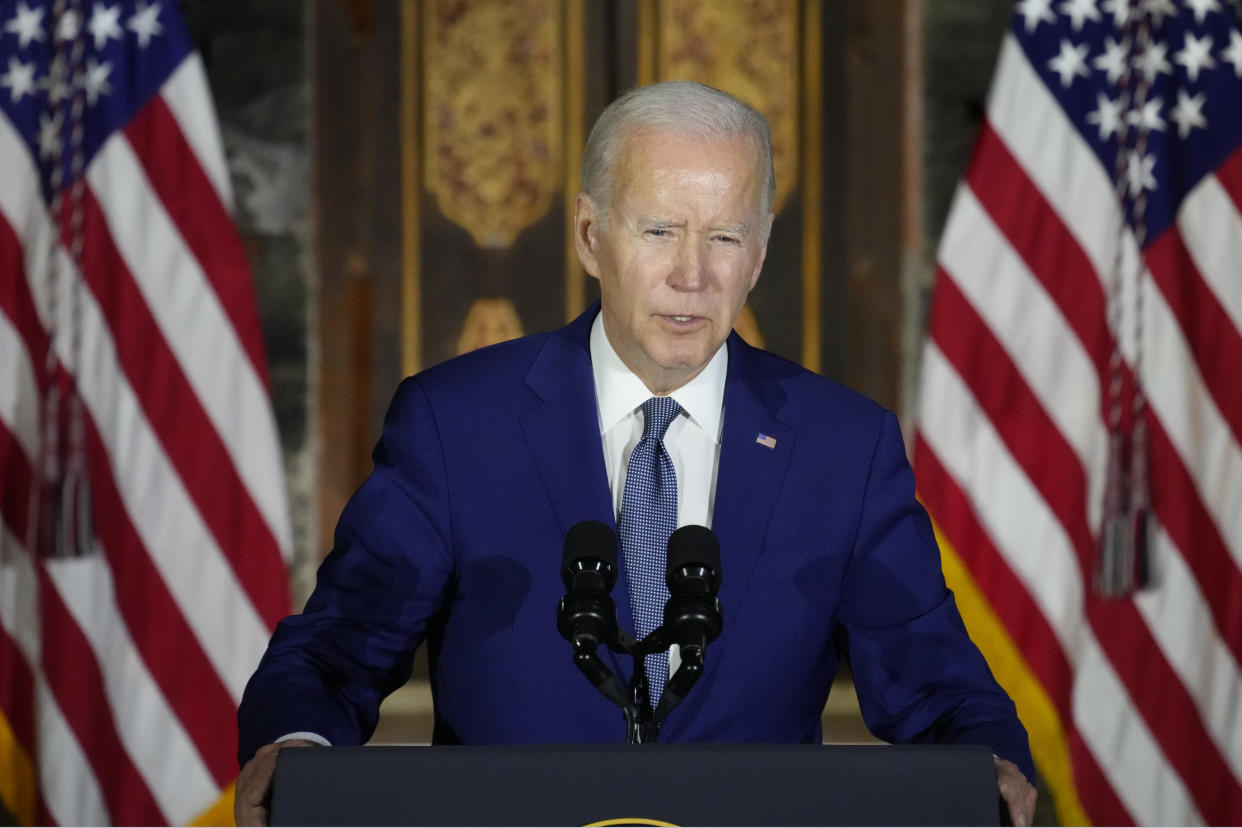 President Biden speaking from a podium at a news conference.