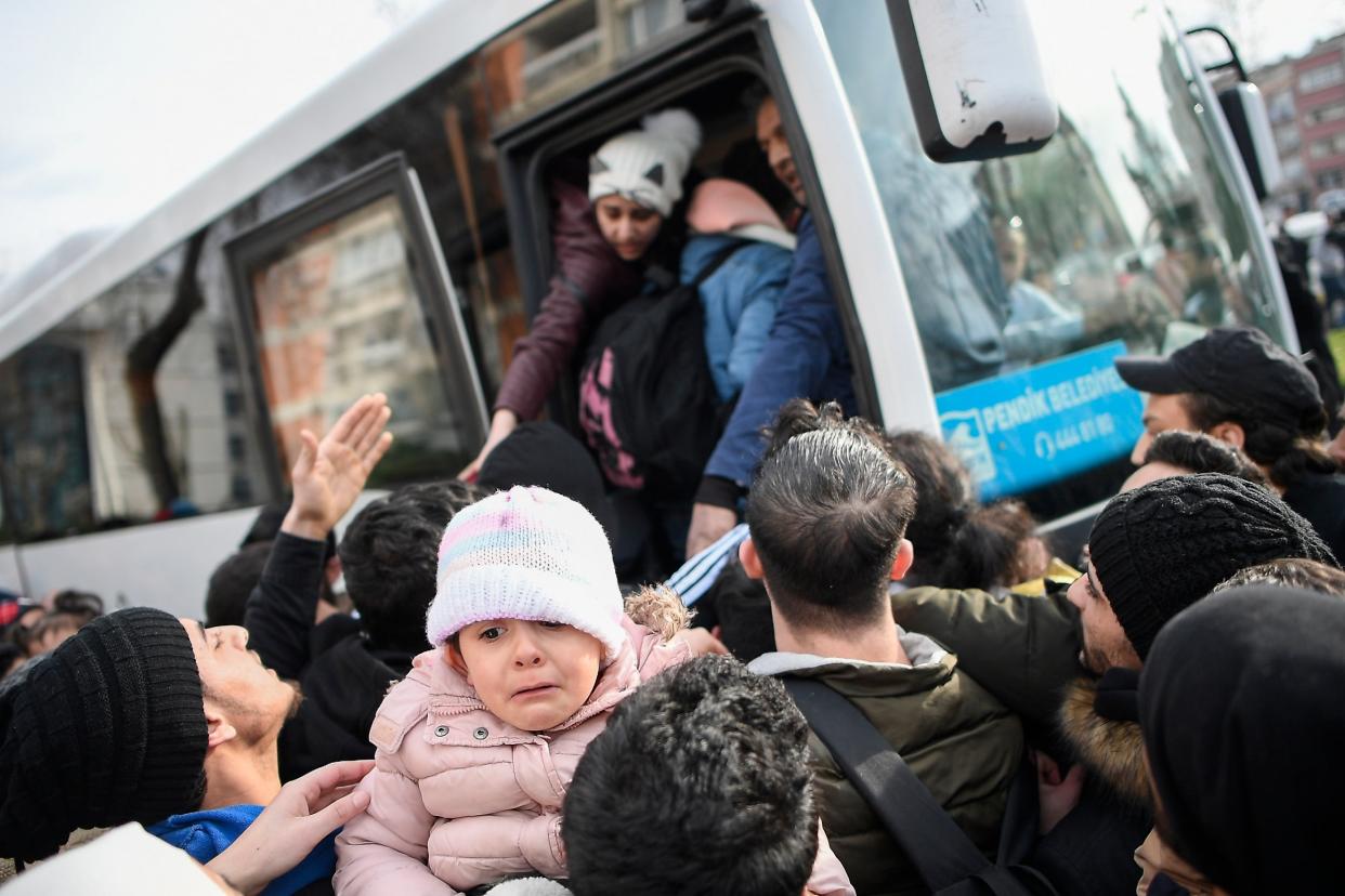 Syrian refugees board a bus as they head to border villages of Edirne province, in Istanbul, hoping to then cross into Europe: EPA