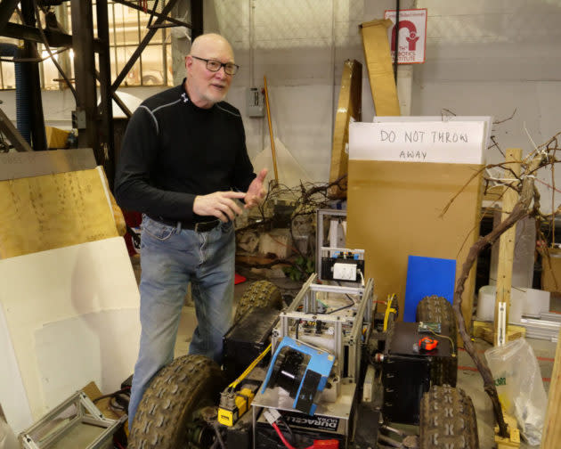 Red Whittaker, founder and director of Carnegie Mellon University’s Field Robotics Center, with Cave Crawler, a robot developed to autonomously map underground mines. (GeekWire Photo / Todd Bishop) <strong><a href="https://www.geekwire.com/2018/robotics-pioneer-red-whittaker-wants-put-robot-moon-land-amazon-backyard/" rel="nofollow noopener" target="_blank" data-ylk="slk:Read the story.;elm:context_link;itc:0;sec:content-canvas" class="link ">Read the story.</a></strong>