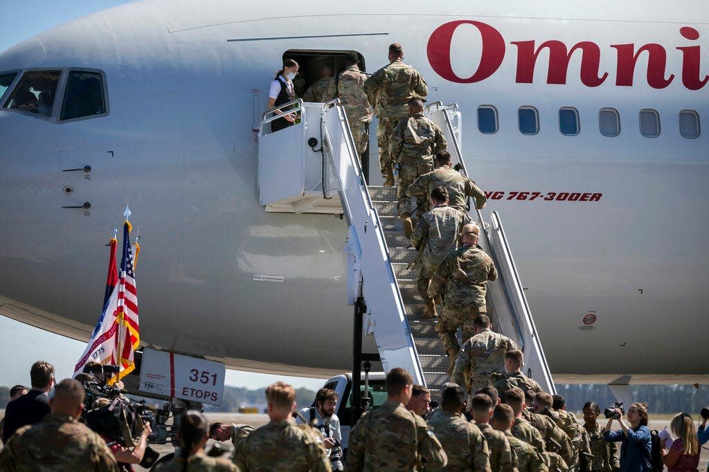 Soldiers from the U.S. Army 3rd Infantry Division board a plane at Hunter Army Airfield. A new bill would make it easier for military spouses to have their professional licenses transfer from out of state so they could work in Georgia.