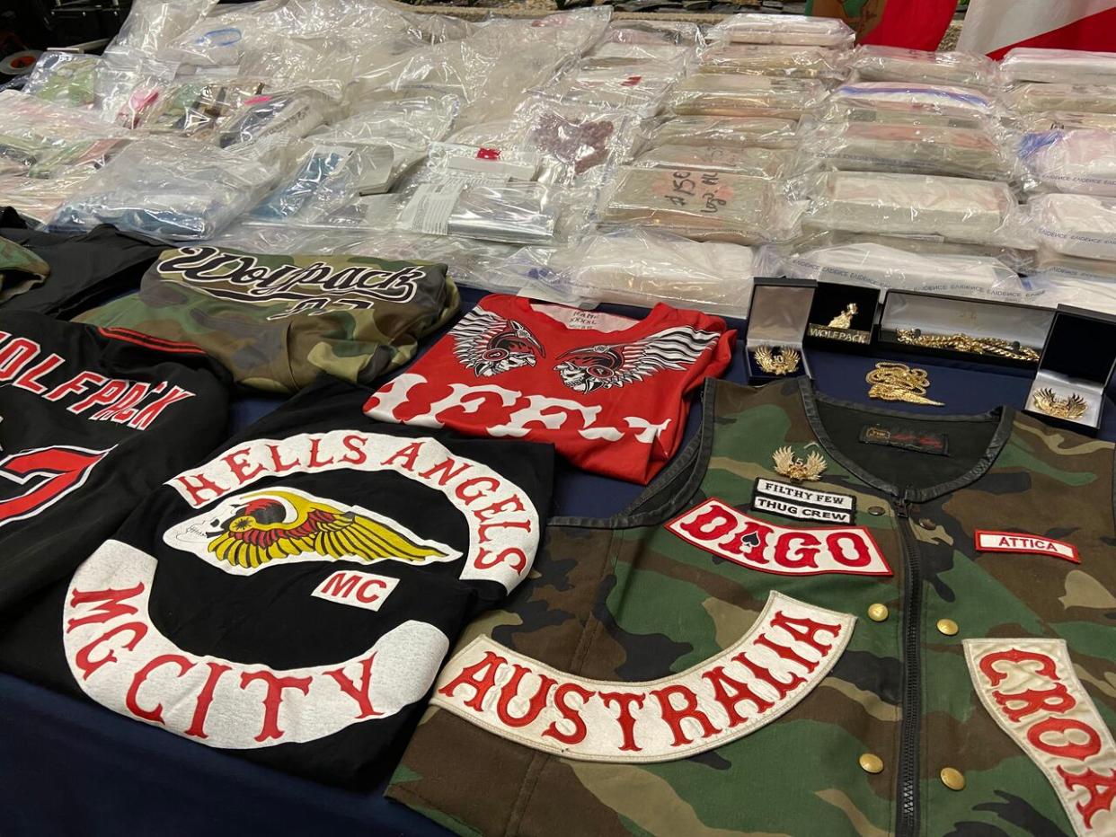 Hells Angels patches and paraphernalia are displayed by Manitoba RCMP in March 2023, after arrests and the seizure of more than $70 million in illicit drugs. (Ron Boileau/CBC - image credit)