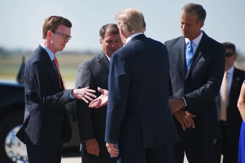 South Dakota Rep. Dusty Johnson, Sen. Mike Rounds and Sen. John Thune greet President Donald Trump in Sioux Falls in 2018.