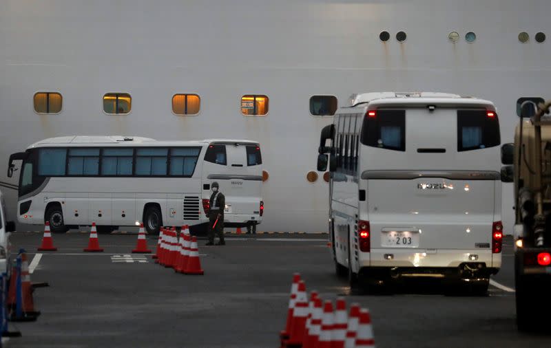 Buses arrive at the cruise ship Diamond Princess at Daikoku Pier Cruise Terminal in Yokohama