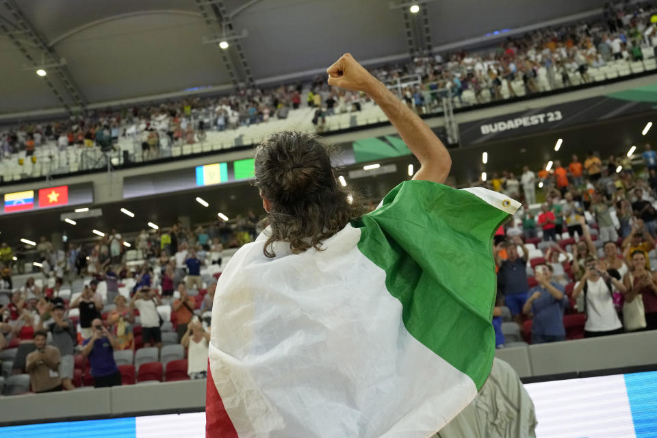 Gianmarco Tamberi, of Italy, celebrates after winning the gold medal in the Men's high jump final during the World Athletics Championships in Budapest, Hungary, Tuesday, Aug. 22, 2023. (AP Photo/Ashley Landis)