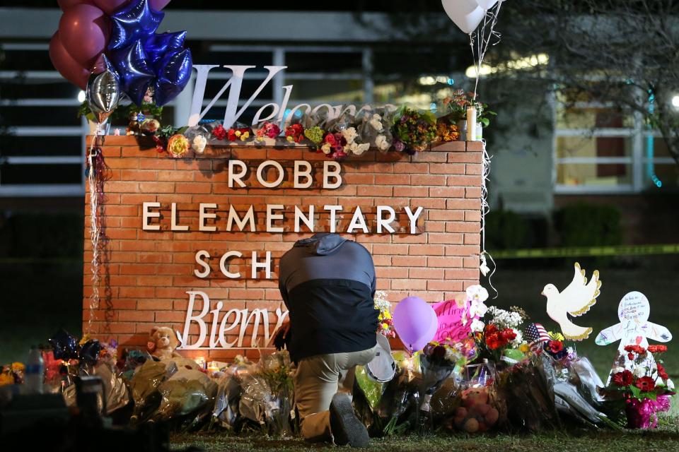 Kyev Tatum, pastor from New Mount Rose Missionary Baptist in Fort Worth, visits the memorial to shooting victims at Robb Elementary School on Wednesday.