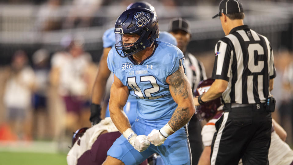 FILE - Old Dominion linebacker Jason Henderson (42) celebrates after a tackle during an NCAA college football game on Friday, Sept. 2, 2022, in Norfolk, Va. Henderson has been selected to The Associated Press midseason All-America team, Wednesday, Oct. 18, 2023. (AP Photo/Mike Caudill, File)