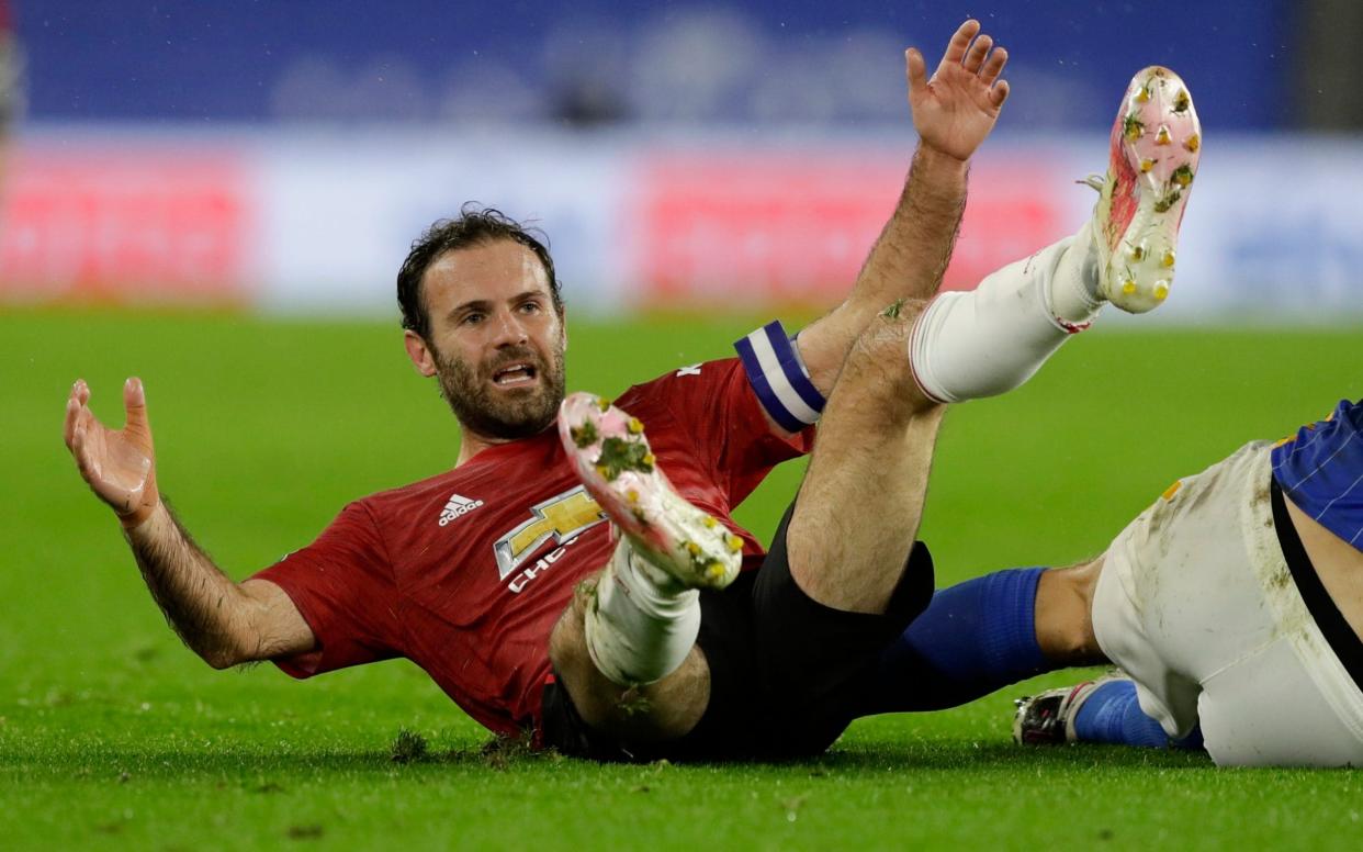 Manchester United's Juan Mata reacts after he was fouled during the English League Cup fourth round soccer match between Brighton and Manchester United  - AP