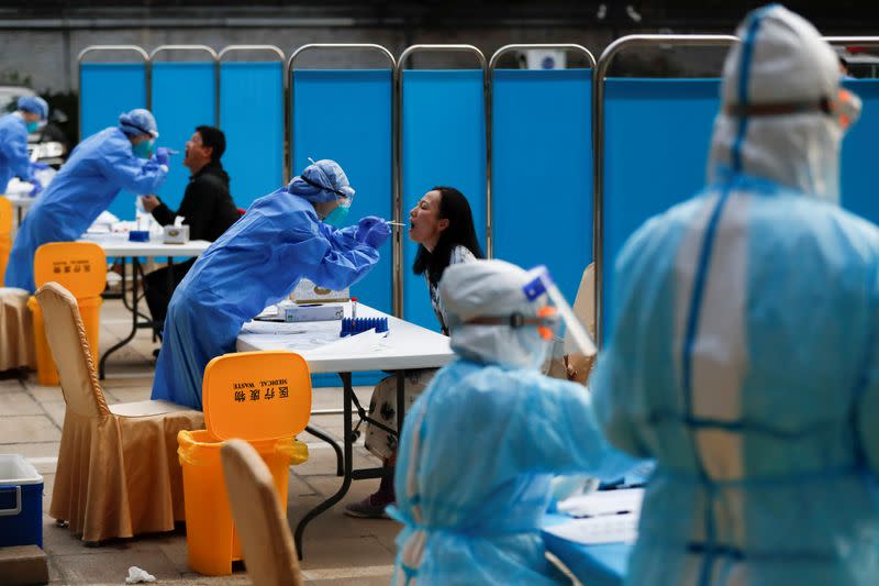 Journalists get tested for the coronavirus disease (COVID-19) before attending the closing session of the National People's Congress (NPC) in Beijing