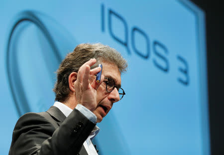 Philip Morris International's CEO Andre Calantzopoulos holds the new IQOS 3 devices at a news conference in Tokyo, Japan, October 23, 2018. REUTERS/Kim Kyung-Hoon