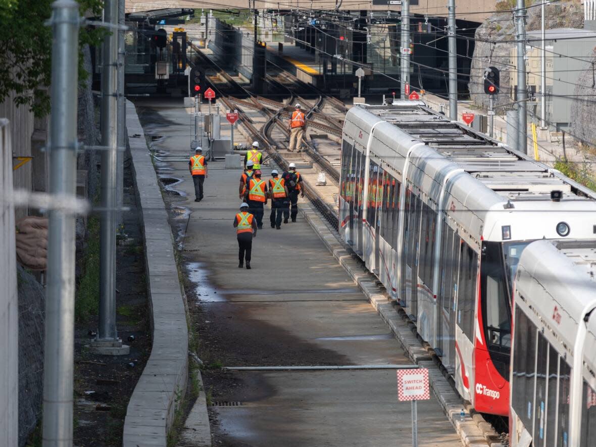 The city's general manager of transit services says the failure of an axle wheel hub assembly on an O-Train in July could be linked to the problem that caused this train to derail at Tunney's Pasture station on Aug. 8, 2021. (Alexander Behne/CBC - image credit)