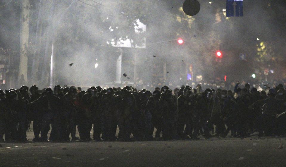 Riot police move to disperse protesters during a rally against the results of a parliamentary vote in Bishkek, Kyrgyzstan, Monday, Oct. 5, 2020. Large crowds of people have gathered in the center of Kyrgyzstan’s capital to protest against the results of a parliamentary election, early results of which gave the majority of seats to two parties with ties to the ruling elites amid allegations of vote buying. (AP Photo/Azamat Imanaliyev)