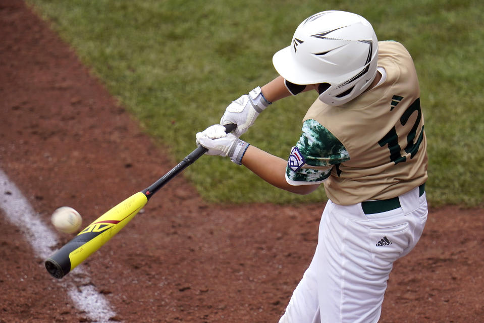 Taiwan's Lai Yu-Jun hits a double against Canada during the third inning of a baseball game at the Little League World Series tournament in South Williamsport, Pa., Thursday, Aug. 17, 2023. (AP Photo/Tom E. Puskar)