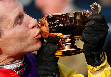 Horse Racing - Cheltenham Festival - Cheltenham Racecourse, Cheltenham, Britain - March 16, 2018 Richard Johnson celebrates with the trophy after riding Native River to victory in the 15.30 Timico Cheltenham Gold Cup Chase Action Images via Reuters/Andrew Boyers