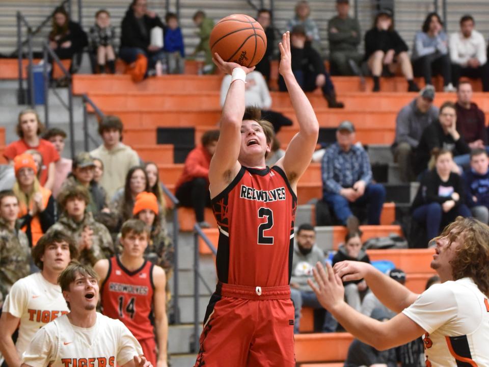 Clinton's Ryan Tschirhart shoots over the Hudson defense Thursday night.